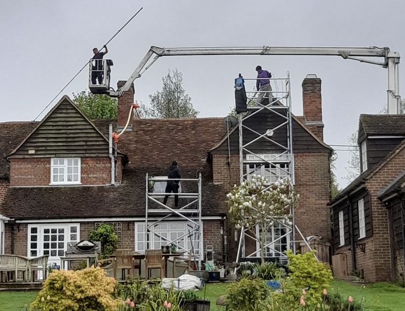 The Roof Moss Cleaners using cherry picker and scaffolding to clean roof safely and professionally in Leighton Buzzard, Bedfordshire